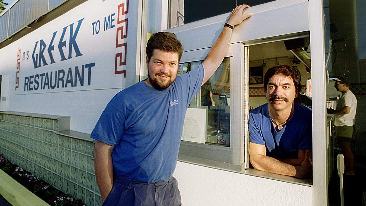 Jim Wick and Johnnie Dimakis (window) at the original Tacoma restaurant in this June 1994 TNT file photo. It’s Greek To Me moved to its current location at 1702 6th Ave. in 2013.