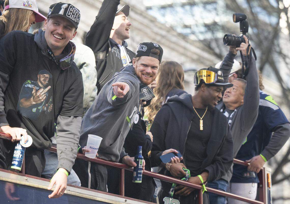 Seattle Seahawks quarterback Sam Darnold points to the crowd during the Super Bowl parade through downtown on Wednesday, Feb. 11, 2026, in Seattle.