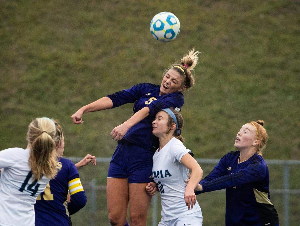 PuyallupÕs Sydney Evans goes up for a header during the first half. Puyallup played Olympia in a soccer match at Memorial Stadium in Federal Way, Wash., on Saturday, Nov. 9, 2019.