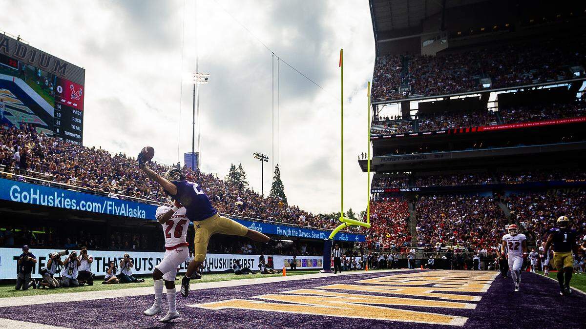 Washington Huskies wide receiver Aaron Fuller (2) makes a one-handed catch over Eastern Washington Eagles defensive back Darreon Moore (26) during the first quarter. The Washington Huskies played the Eastern Washington Eagles in a NCAA football game at Husky Stadium in Seattle, Wash., on Saturday, Aug. 31, 2019.