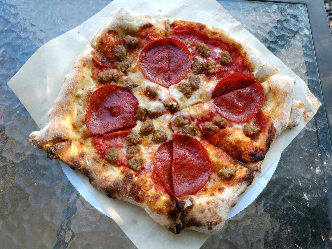 The New York pizza with sausage and pepperoni from Sirius Wood Fired Pizza.