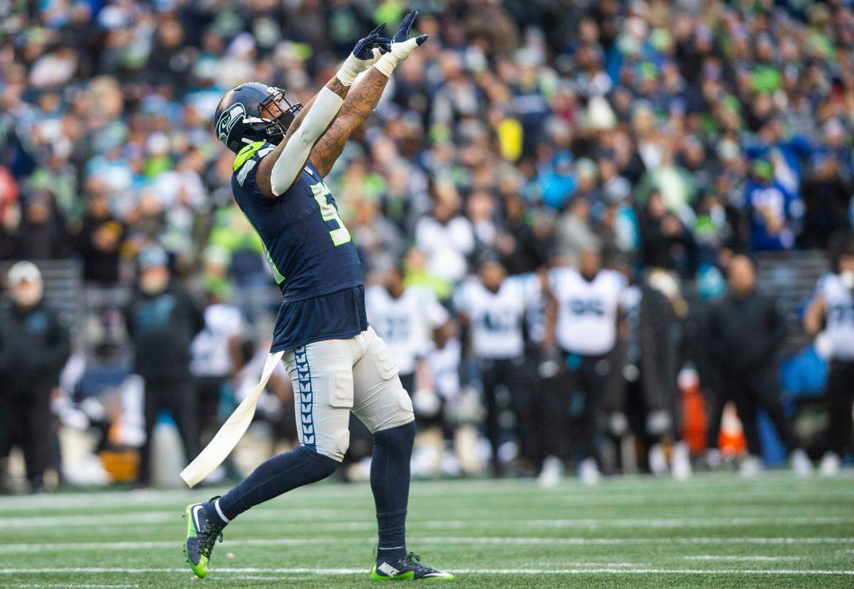 Seahawks outside linebacker Darrell Taylor (52) celebrates after sacking Carolina Panthers quarterback Sam Darnold (14) twice in the second quarter of an NFL game at Lumen Field in Seattle, Dec. 11, 2022.