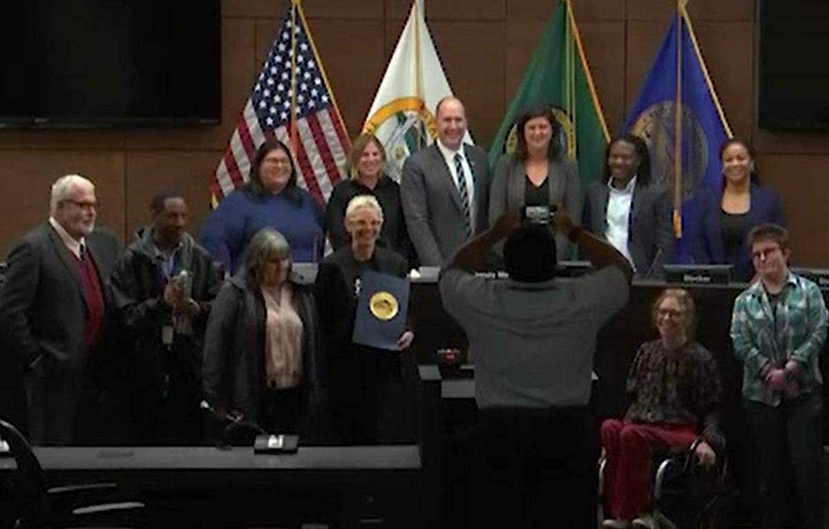 Steven Bird, far left, poses with other disabled citizens after a proclamation on a Week Without Driving was issued by the Tacoma City Council on Sept. 26, 2023.