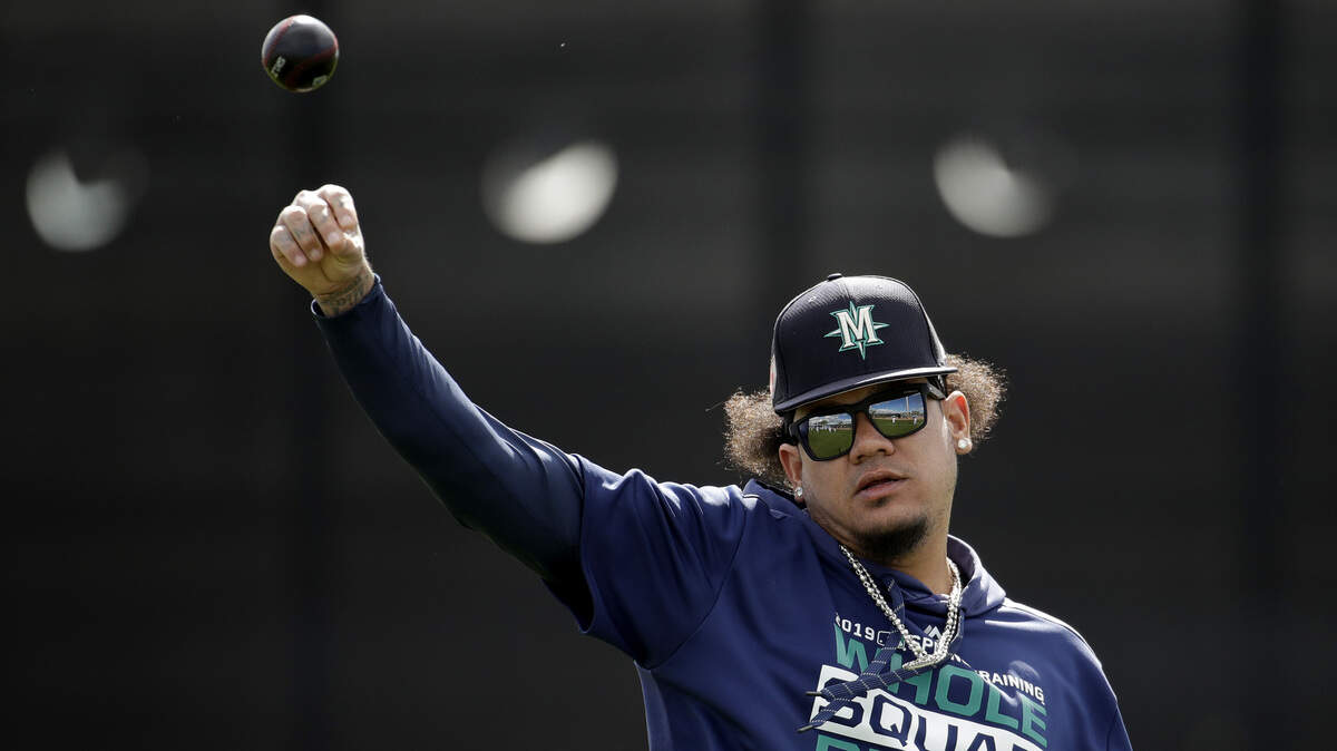 Seattle Mariners pitcher Felix Hernandez throws during spring training baseball practice Saturday, Feb. 16, 2019, in Peoria, Ariz. (AP Photo/Charlie Riedel)