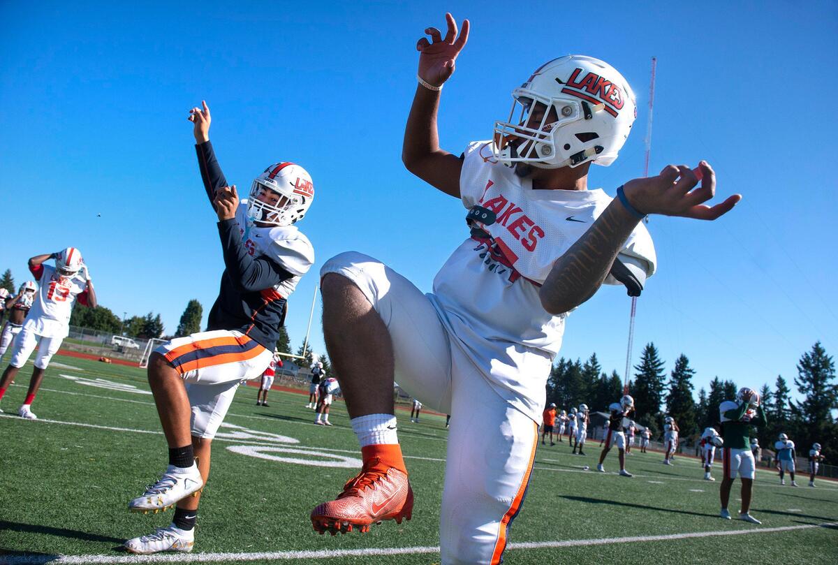 Lakes sophomore Devon Nofoa-Masoe (left) dances with teammate Jaydon McMillon during football practice at Lake High School in Lakewood on Oct. 1, 2019.