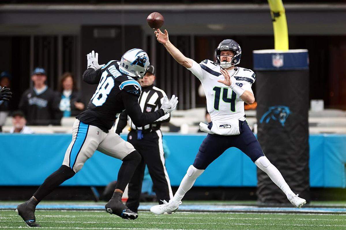 CHARLOTTE, NORTH CAROLINA - DECEMBER 28: Sam Darnold #14 of the Seattle Seahawks throws a pass in front of D.J. Wonnum #98 of the Carolina Panthers during the first quarter at Bank of America Stadium on December 28, 2025 in Charlotte, North Carolina. (Photo by Jared C. Tilton/Getty Images)