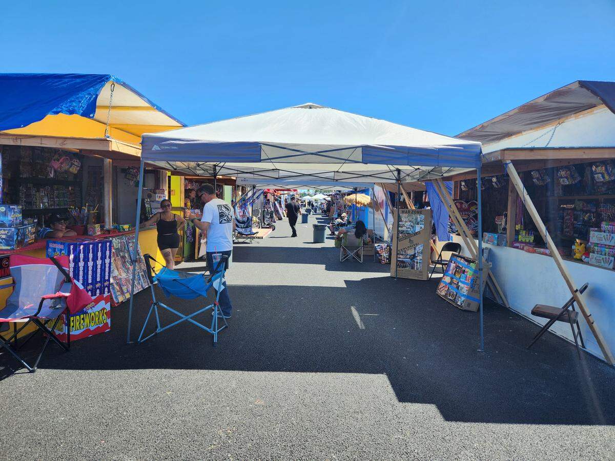 Vendors and customers walk around at Firecracker Alley in Tacoma on June 29, 2023. The venue features over 100 booths and around 20 concession stands.