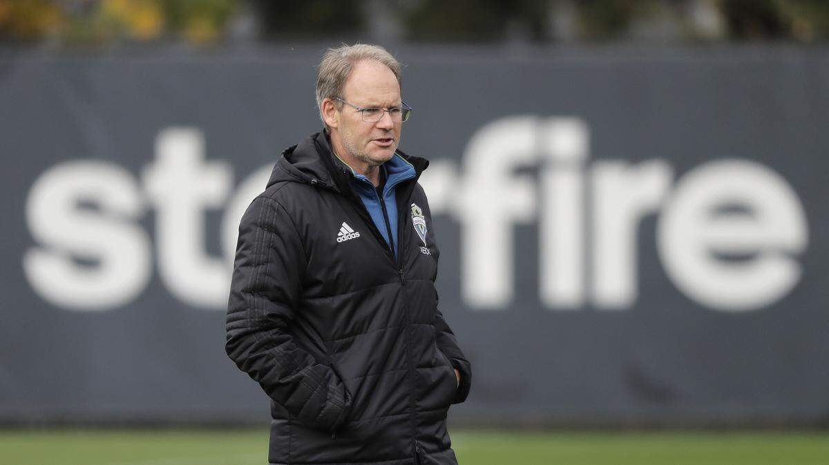 Seattle Sounders head coach Brian Schmetzer walks on the pitch, Wednesday, Nov. 7, 2018, during MLS soccer training in Tukwila, Wash. The Sounders will face the Portland Timbers Thursday in Seattle in the second leg of the MLS soccer Western Conference semifinal round of the MLS playoffs. (AP Photo/Ted S. Warren)