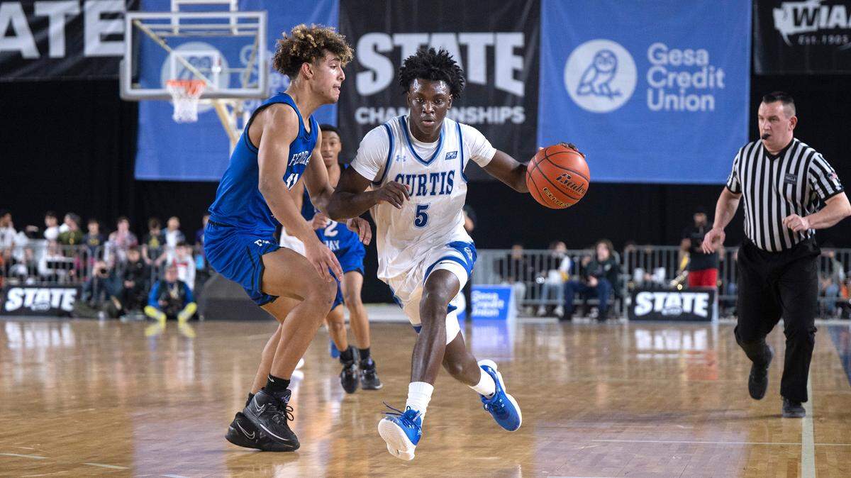 Curtis’ Zoom Diallo pushes the ball up court against Federal Way defender Isaiah Afework during their state semifinal game at the WIAA state basketball tournament in the Tacoma Dome in Tacoma, Washington, on Friday, March 3, 2023. Curtis won the game, 56-43.