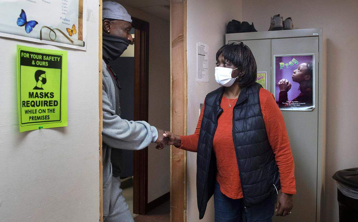 Shelter director Marsha Hopkins thanks staff member Joe Goree at the Shiloh Baptist Church’s new Retreat Center and homeless shelter in Tacoma, Washington, on Wednesday, Nov. 17, 2021.