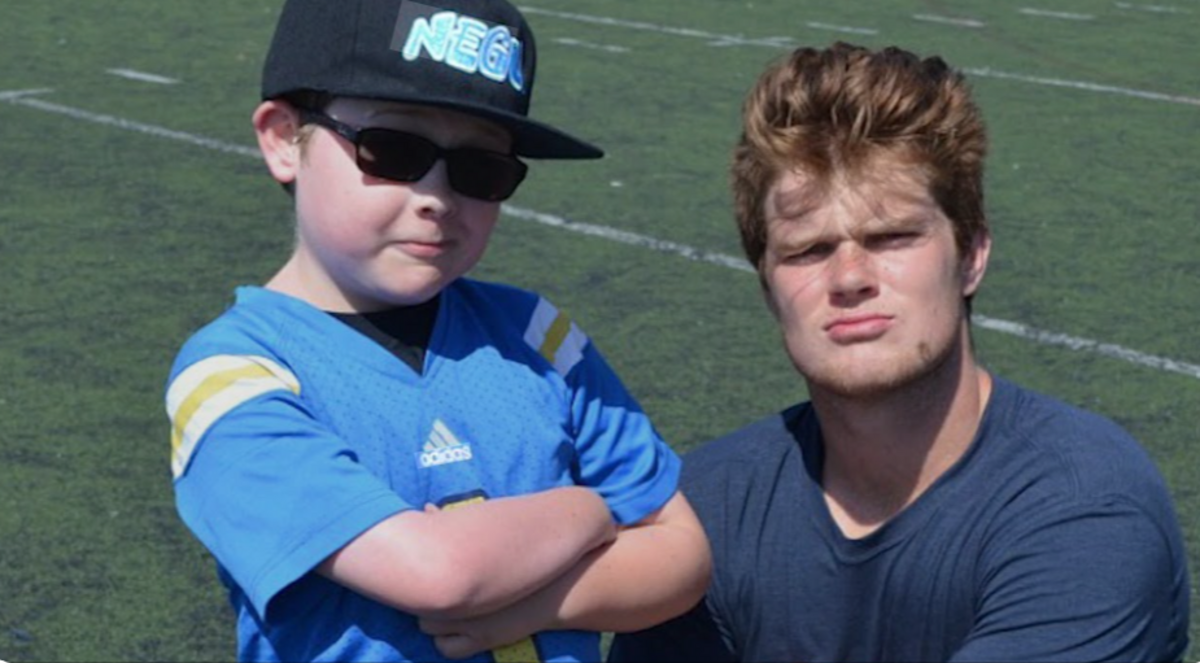 Then-USC quarterback Sam Darnold (right) with “Super Cade” Spinello, who became a UCLA superfan after battling through two brain surgeries and a stroke at the age of 3. They met through the Jessie Rees Foundation. The Seahawks QB wore cleats desgined for the Jessie Rees Foundation to honor “Super Cade” in Seattle’s NFL game at the Tennessee Titans Nov. 23, 2025, for the NFL’s annual My Cause My Cleats weekend.