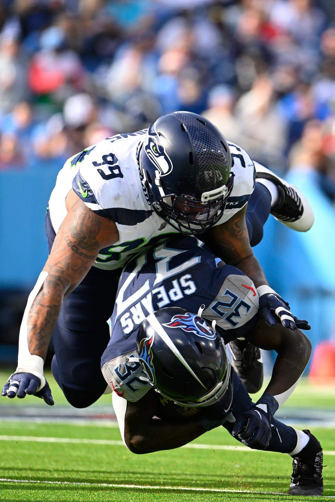 Seattle Seahawks defensive end Leonard Williams (99) tackles Tennessee Titans running back Tyjae Spears during the first half of an NFL football game on Sunday, Dec. 24, 2023, in Nashville, Tenn. (AP Photo/John Amis)