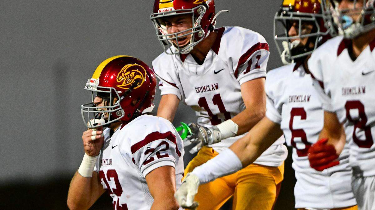 Enumclaw players celebrate after Anthony Mills (22) intercepted a pass by Steilacoom quarterback Drew MacDonald (7) during the second quarter on Friday, Sept. 15, 2023, in Steilacoom.