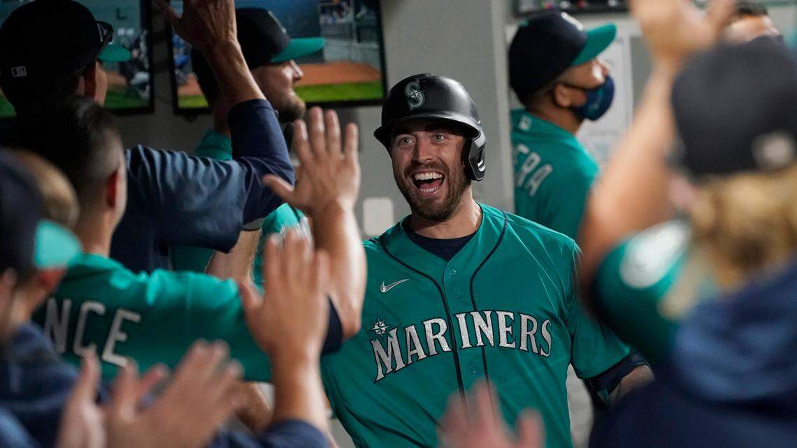 Seattle Mariners’ Tom Murphy reacts in the dugout after hitting a two-run home run to also score Luis Torrens during the second inning of a baseball game against the Arizona Diamondbacks, Friday, Sept. 10, 2021, in Seattle. (AP Photo/Ted S. Warren)