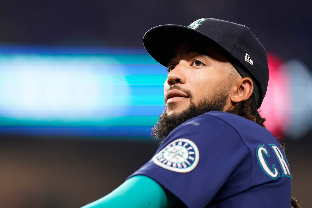 Seattle Mariners shortstop J.P. Crawford looks out of the dugout during the fifth inning of a baseball game against the Miami Marlins, Saturday, April 30, 2022, in Miami. (AP Photo/Wilfredo Lee)