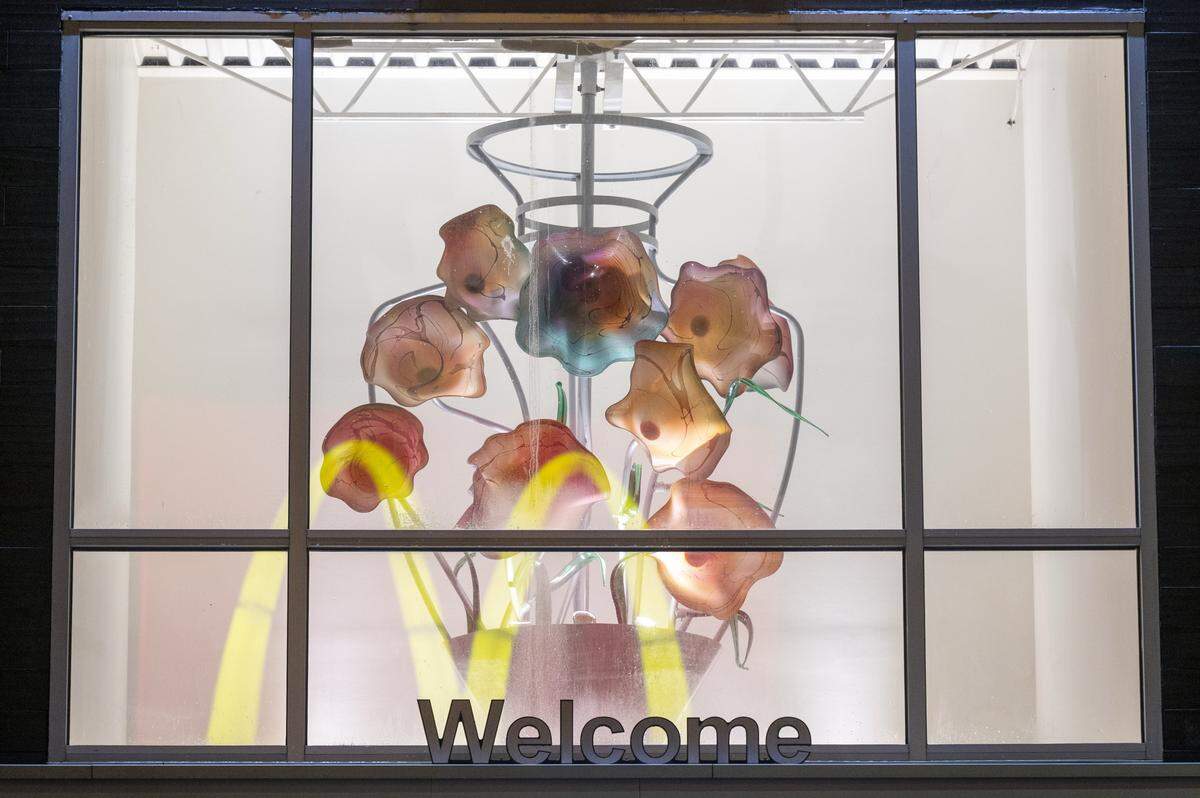 A McDonald's sign is reflected on the sculpture by artist Dennis Mullen as it hangs in the lobby of the McDonald's on Tacoma Avenue on Friday, Dec. 19, 2025, in Tacoma, Wash.