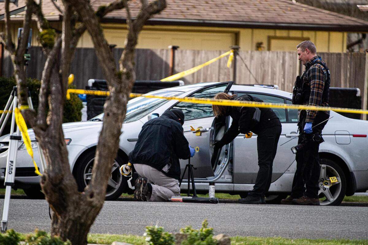Police investigate after a drive-by shooting in a residential neighborhood in Puyallup on March 15, 2021. One person died.