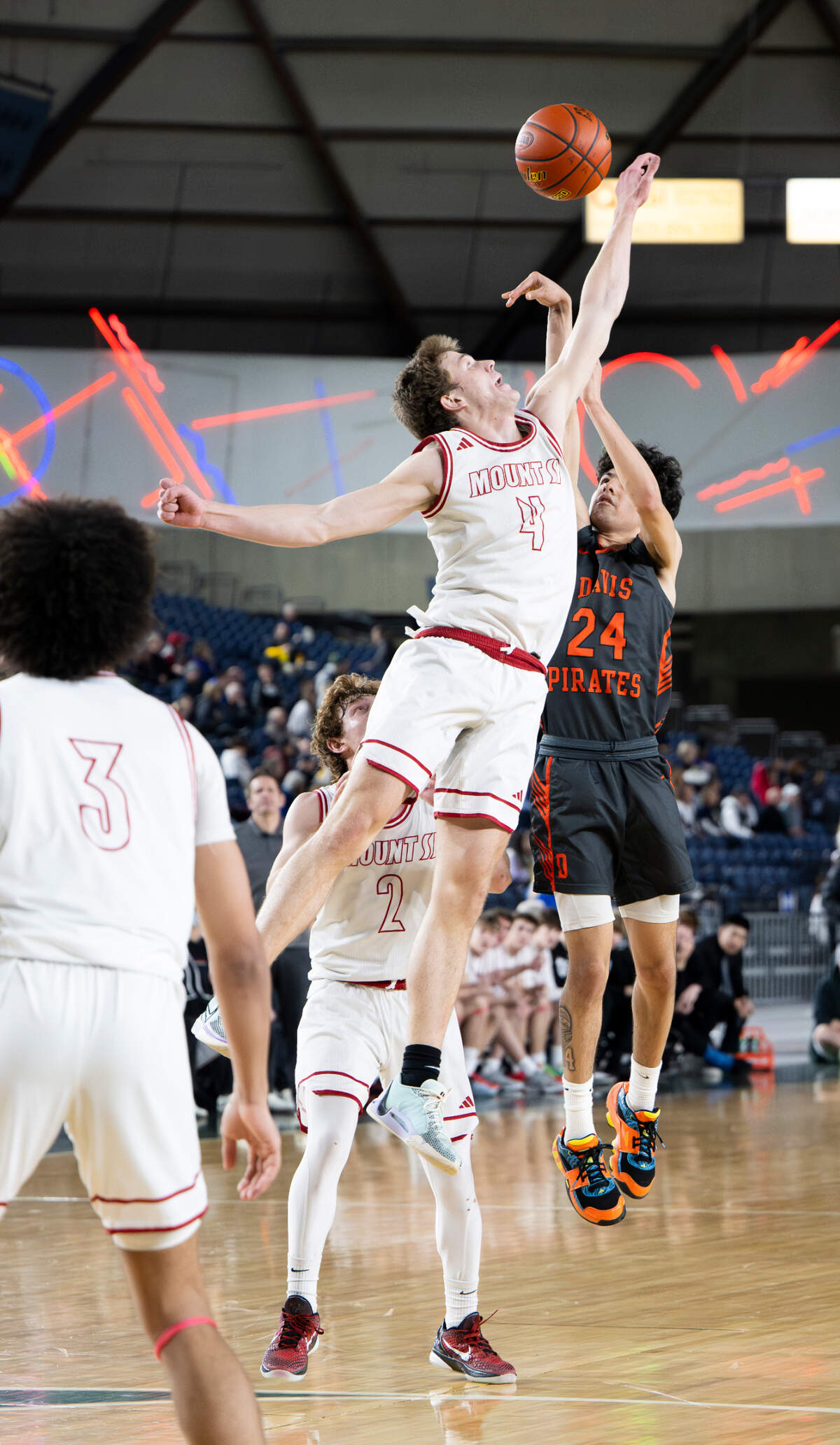 Mount Si’s Trevor Hennig (4) blocks a shot put up by Davis’ Cesar Hernandez (24) during the semifinals game of the Class 4A state tournament at the Tacoma Dome, on Friday, March 1, 2024, in Tacoma, Wash.
