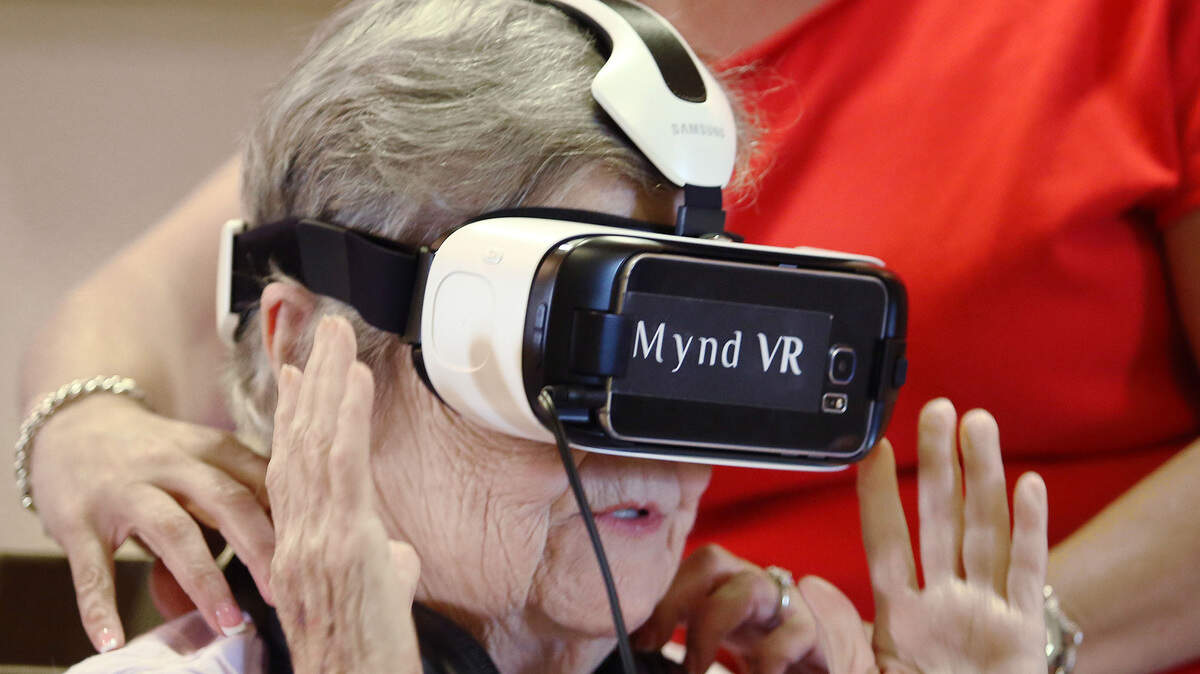 Jane Auchter, 85, a resident at Encore at Avalon Park assisted living facility in Orlando, Fla., takes a virtual-reality trip to the Grand Canyon in 2017. A local forum will consider what the next decade holds for seniors aging in Pierce County.