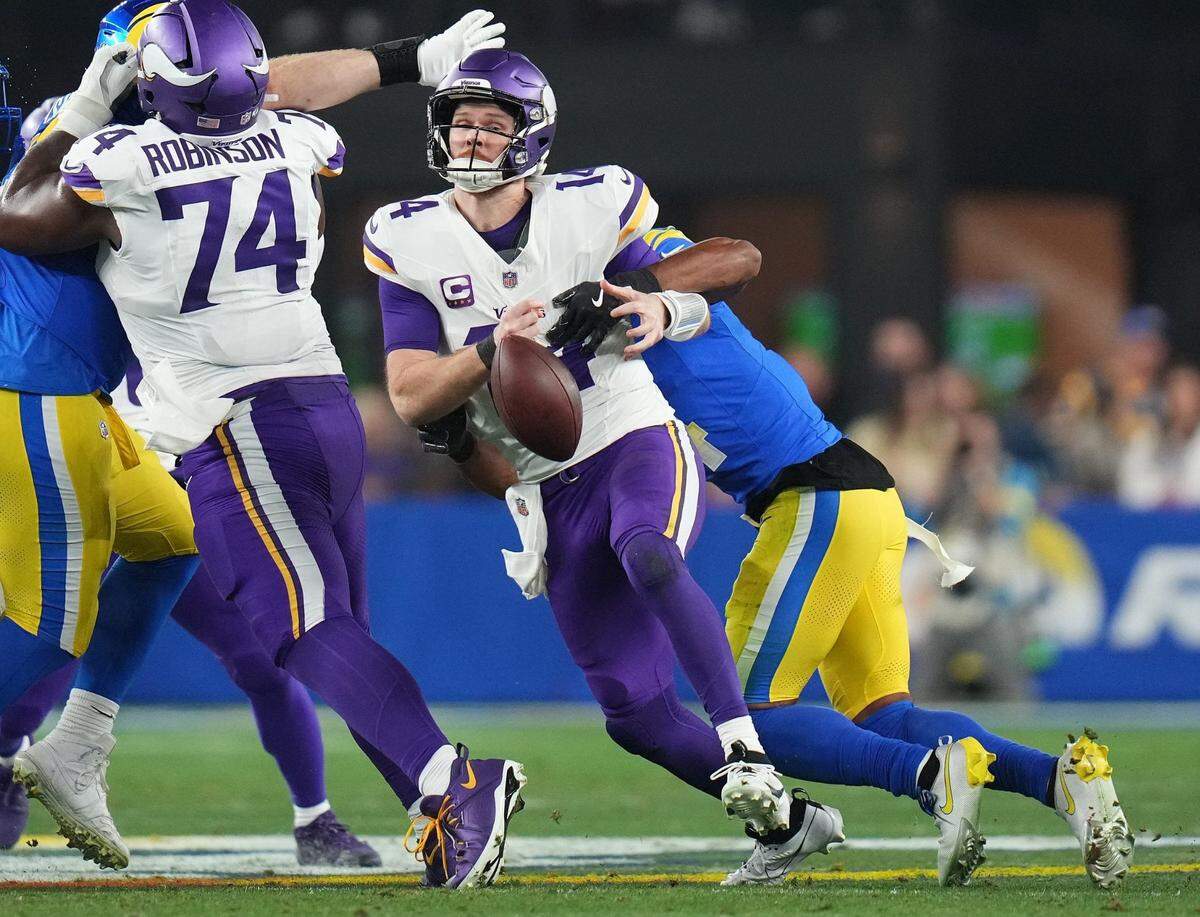 Minnesota Vikings quarterback Sam Darnold (14) fumbles the ball while being sacked by Los Angeles Rams cornerback Ahkello Witherspoon (4) during their playoff game at State Farm Stadium on Jan. 13, 2025, in Glendale.