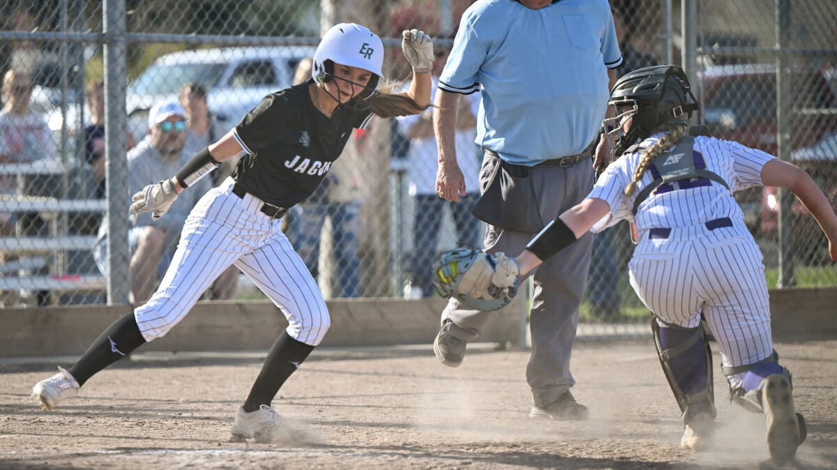 Emerald Ridge’s Ciara Ofield (2) evades the tag from Puyallup’s Kylie Landberg (12) before being tagged out during the softball game at Puyallup High School, on Friday, April 18, 2025, in Puyallup, Wash.