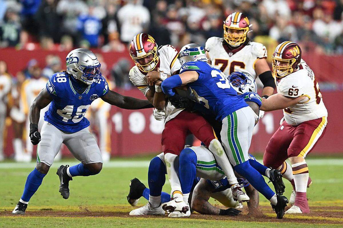 Washington Commanders quarterback Jayden Daniels (5) is hit by Seattle Seahawks safety Ty Okada (39) during the third quarter in the game at Northwest Stadium on November 02, 2025 in Landover, Maryland. (Photo by Greg Fiume/Getty Images)
