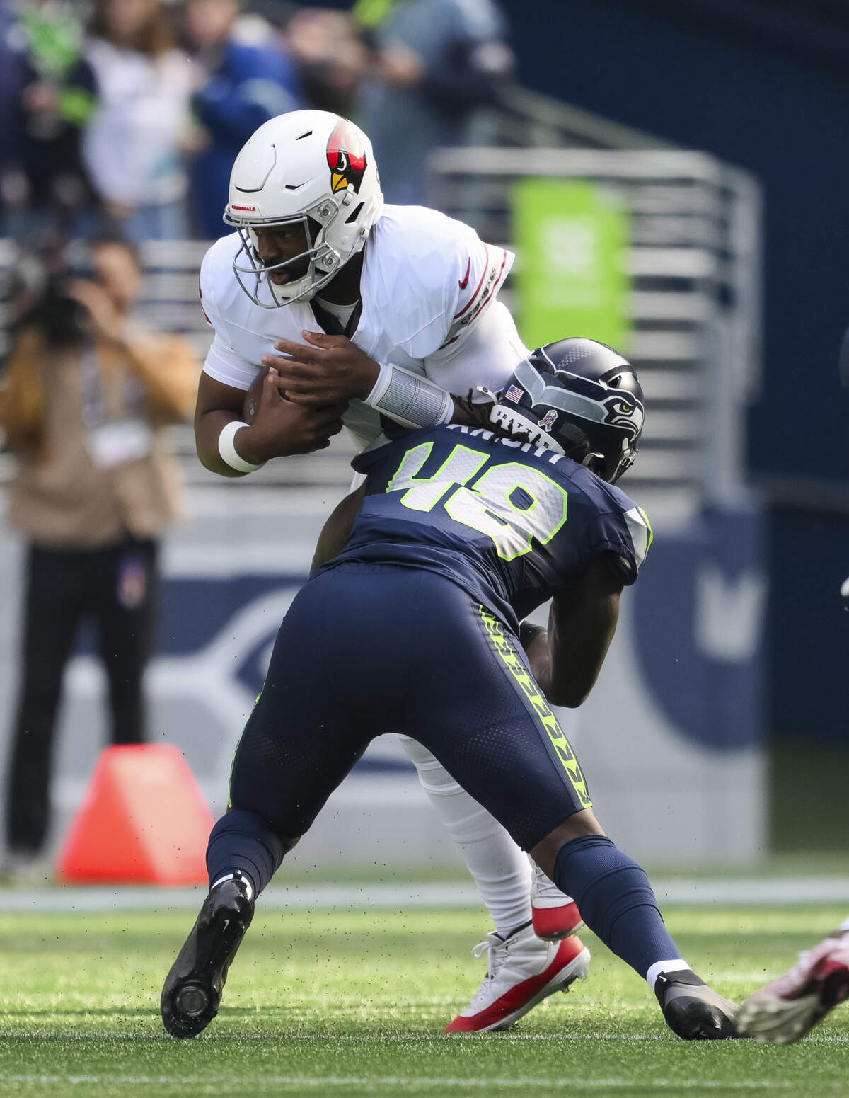 Arizona Cardinals quarterback Jacoby Brissett (7) is tackled by Seattle Seahawks linebacker Tyrice Knight (48) during the first quarter of the game at Lumen Field, on Sunday, Nov. 9, 2025, in Seattle.