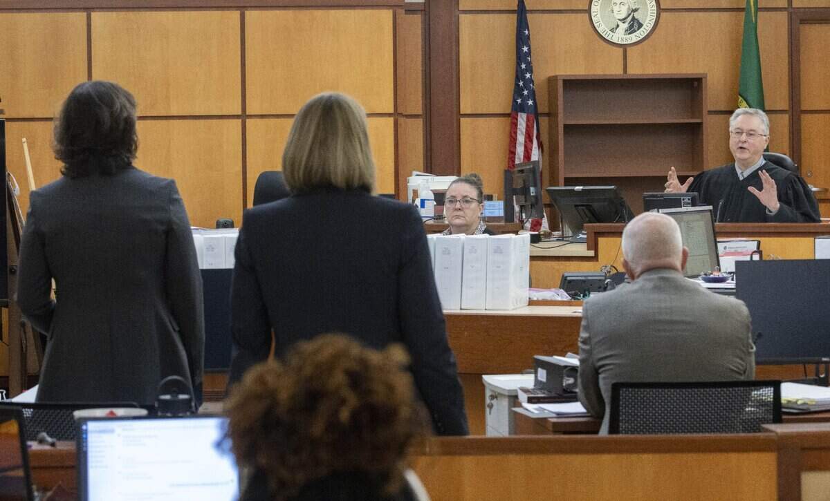 Prosecuting attorney Patty Eakes, left, speaks to Pierce County Superior Court Judge Bryan Chushcoff about possibly delaying the trial for the murder of Manny Ellis because one of the jurors has come down with COVID Wednesday Nov. 15, 2023, in Tacoma, WA. Officers Christopher Burbank, Matthew Collins and Timothy Rankine are charged with his death. At center is prosecuting attorney Lori Nicolavo. The question is being taken to the jury to see how they feel. (Ellen M. Banner / Pool / The Seattle Times)