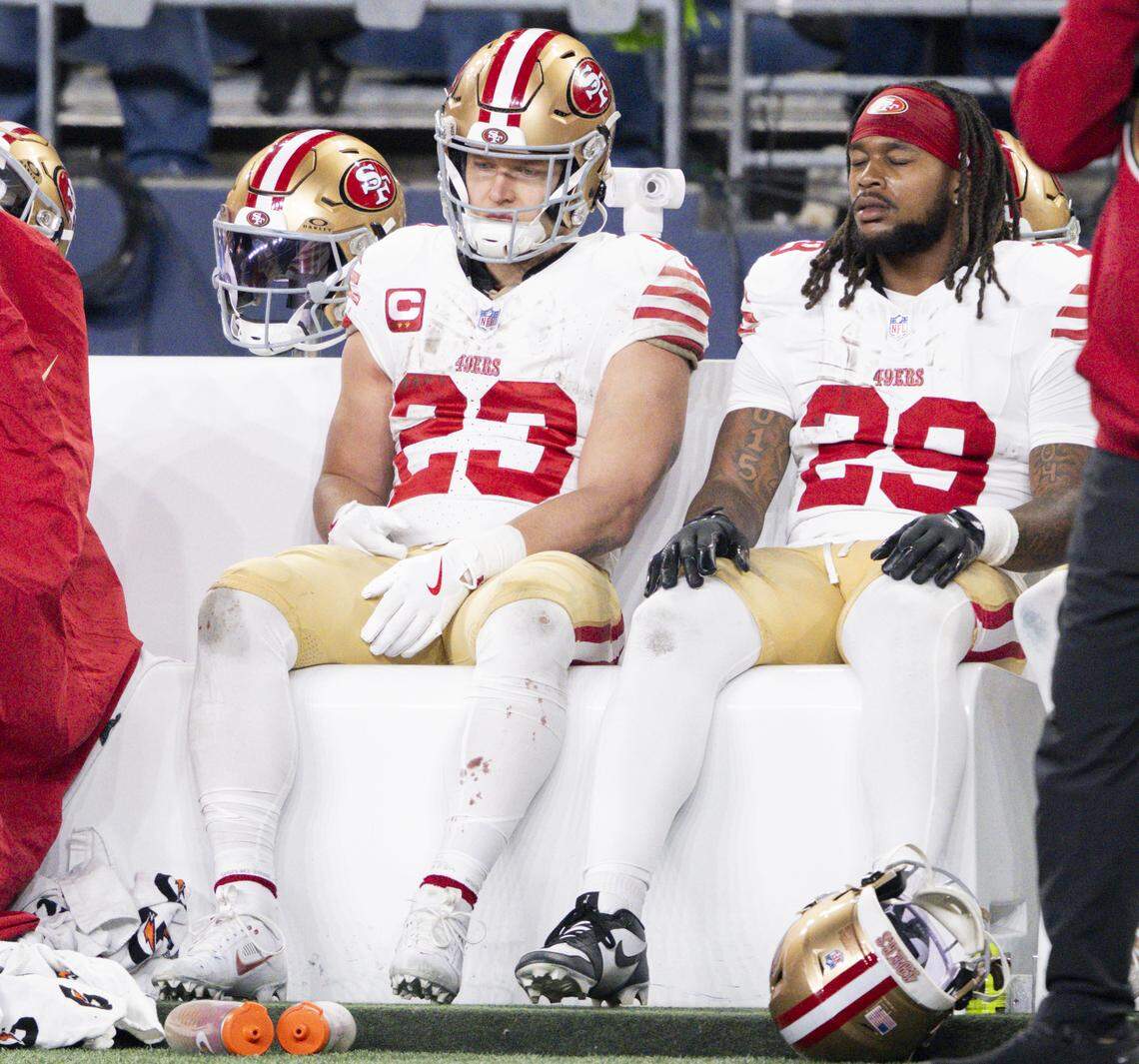 San Francisco 49ers running back Christian McCaffrey (23) and running back Jordan James (29) sit on the bench as most of the starters have been pulled during the fourth quarter of the NFC Divisional Round game against the Seattle Seahawks at Lumen Field, on Saturday, Jan. 17, 2026, in Seattle.