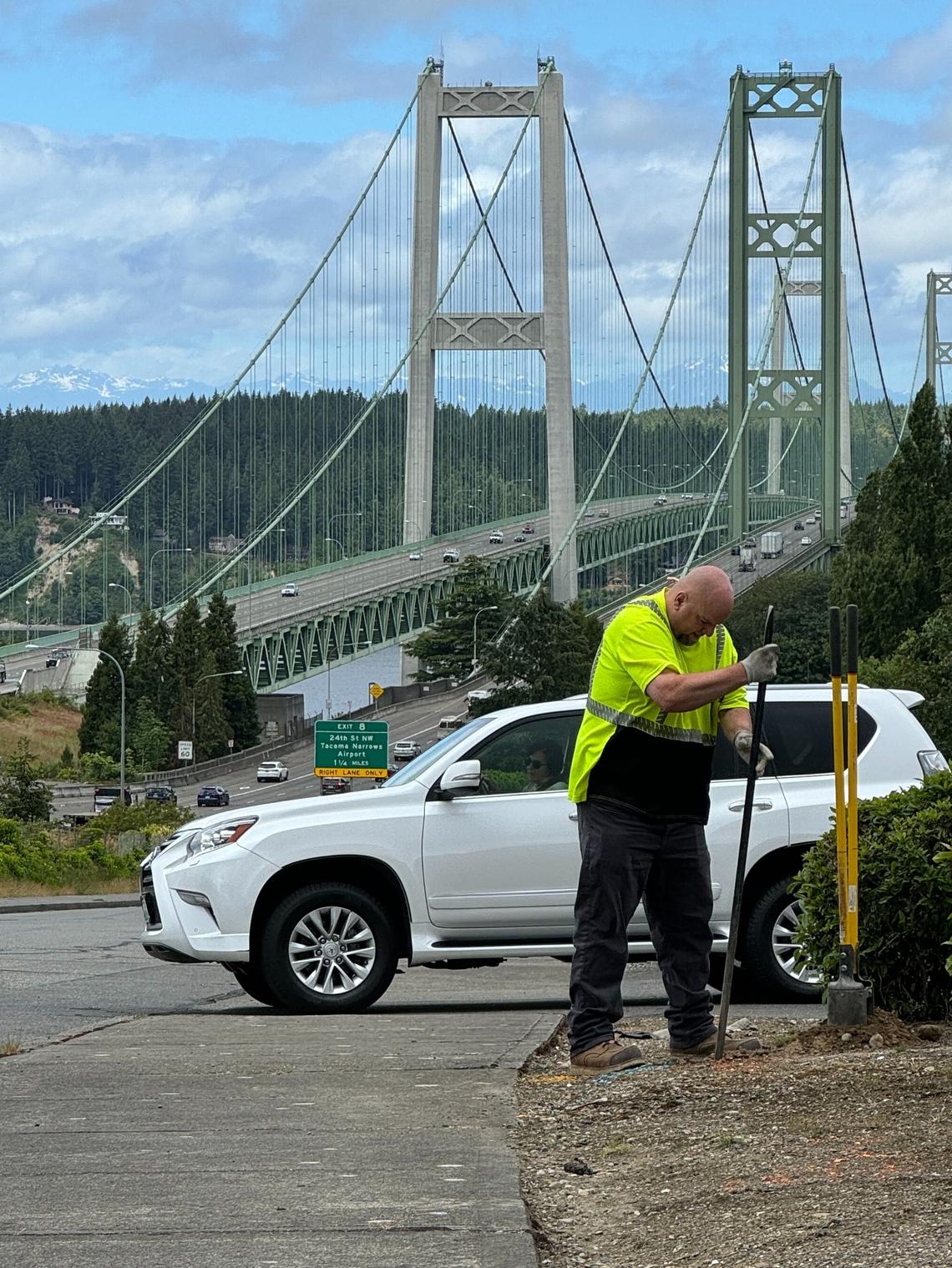 A city employee installs no-parking signs on North 10th Street in June.