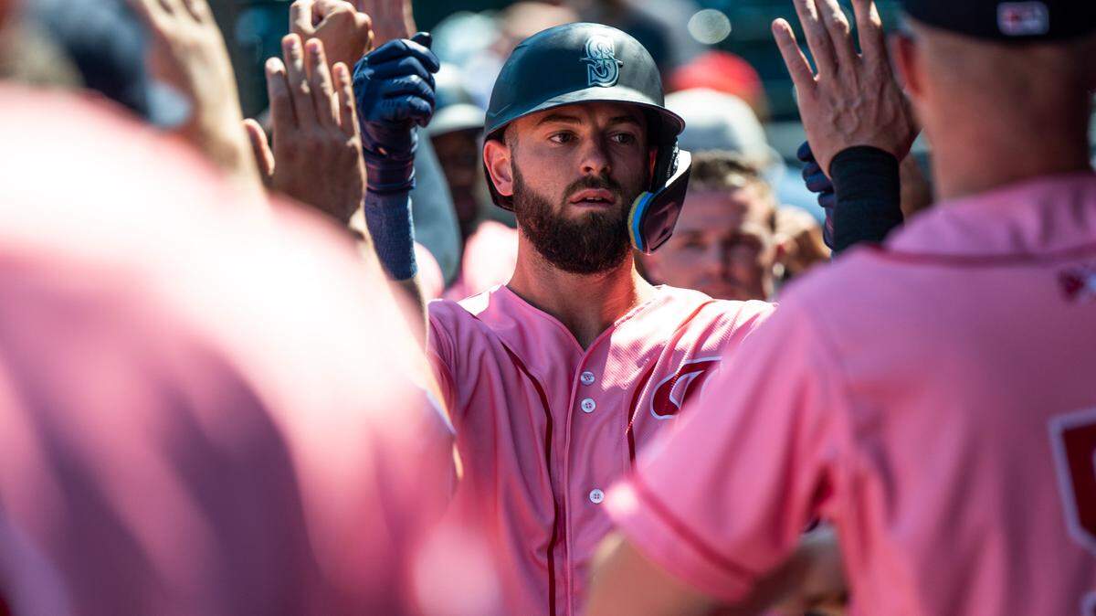 Rainiers right fielder Mitch Haniger, 28, is high-fived by his teammates in the dugout after hitting a home run in the second inning of the game at Cheney Stadium in Tacoma on Sunday, July 31, 2022. The Rainiers defeated El Paso 8-3.