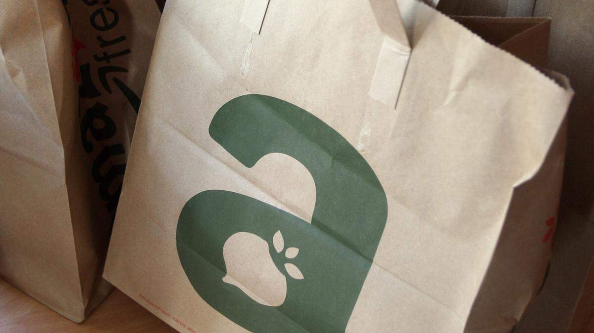 FILE - In this Aug. 23, 2007 file photo, an Amazon Fresh grocery delivery arrives in brown paper bags at a residence on Mercer Island, Wash. After testing in Seattle for several years, Amazon has since expanded its grocery service to Los Angeles, San Francisco, Philadelphia and parts of New York. (AP Photo/Joe Nicholson, File)