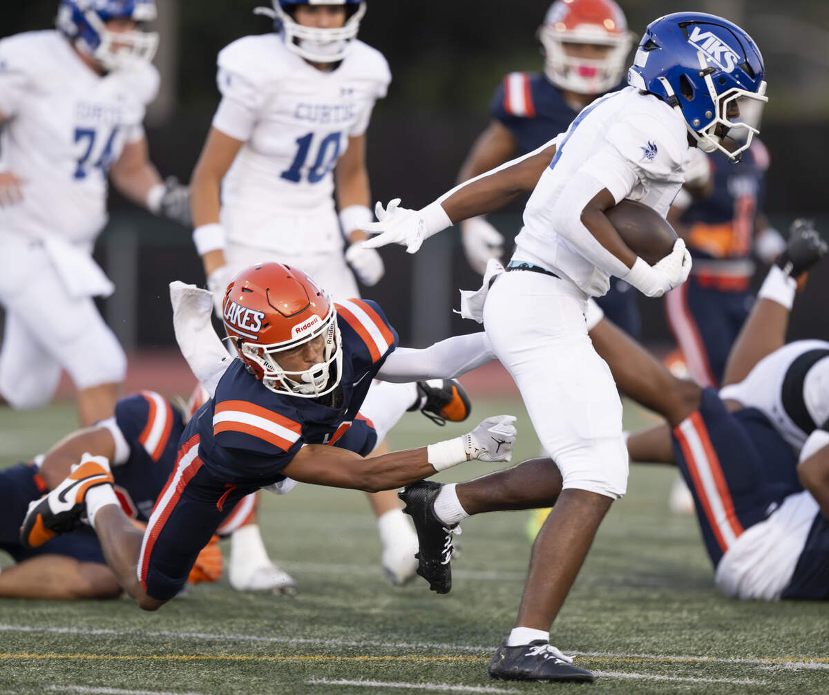 Curtis running back Alijah Johnson (1) makes Lakes defensive back Corey Irish (3) miss during the first half of the game at Harry Lang Stadium, on Friday, Sept. 19, 2025, in Lakewood, Wash.