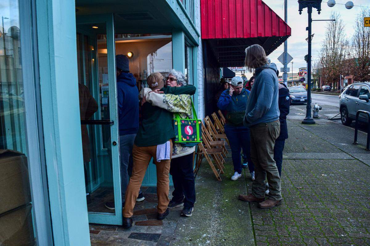 Saracristina Garcia of Tacoma hugs the Howdy Bagel employee who opened the doors Wednesday morning. “They make an amazing product, but what they’ve created here with the people and the atmosphere is really special and needed,” she said.