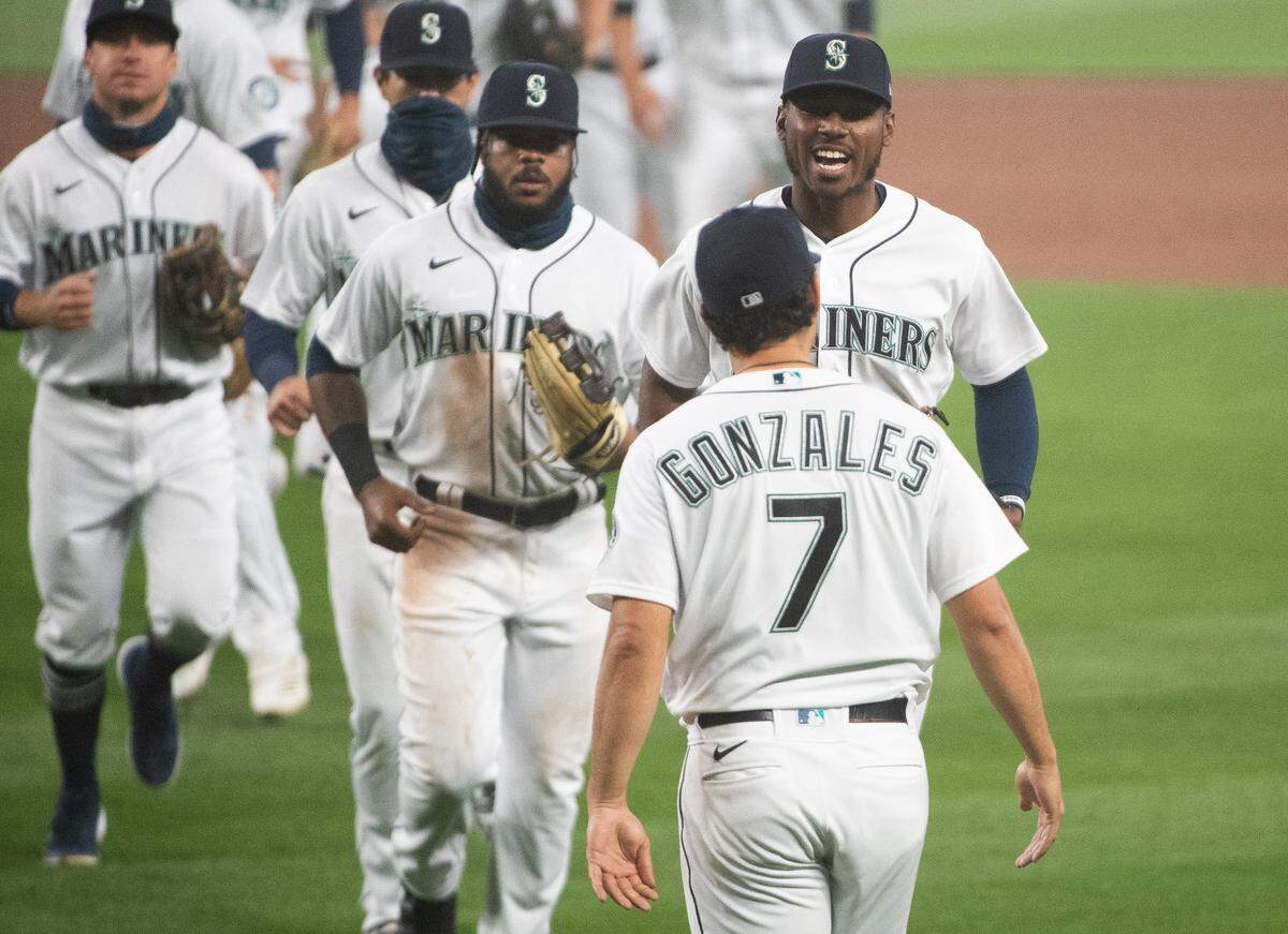 Seattle Mariners right fielder Kyle Lewis (1) celebrates with Seattle Mariners starting pitcher Marco Gonzales (7) after the first game. The Seattle Mariners played the Oakland Athletics in a Major League Baseball game at T-Mobile Park in Seattle, Wash., on Monday, Sept. 14, 2020.