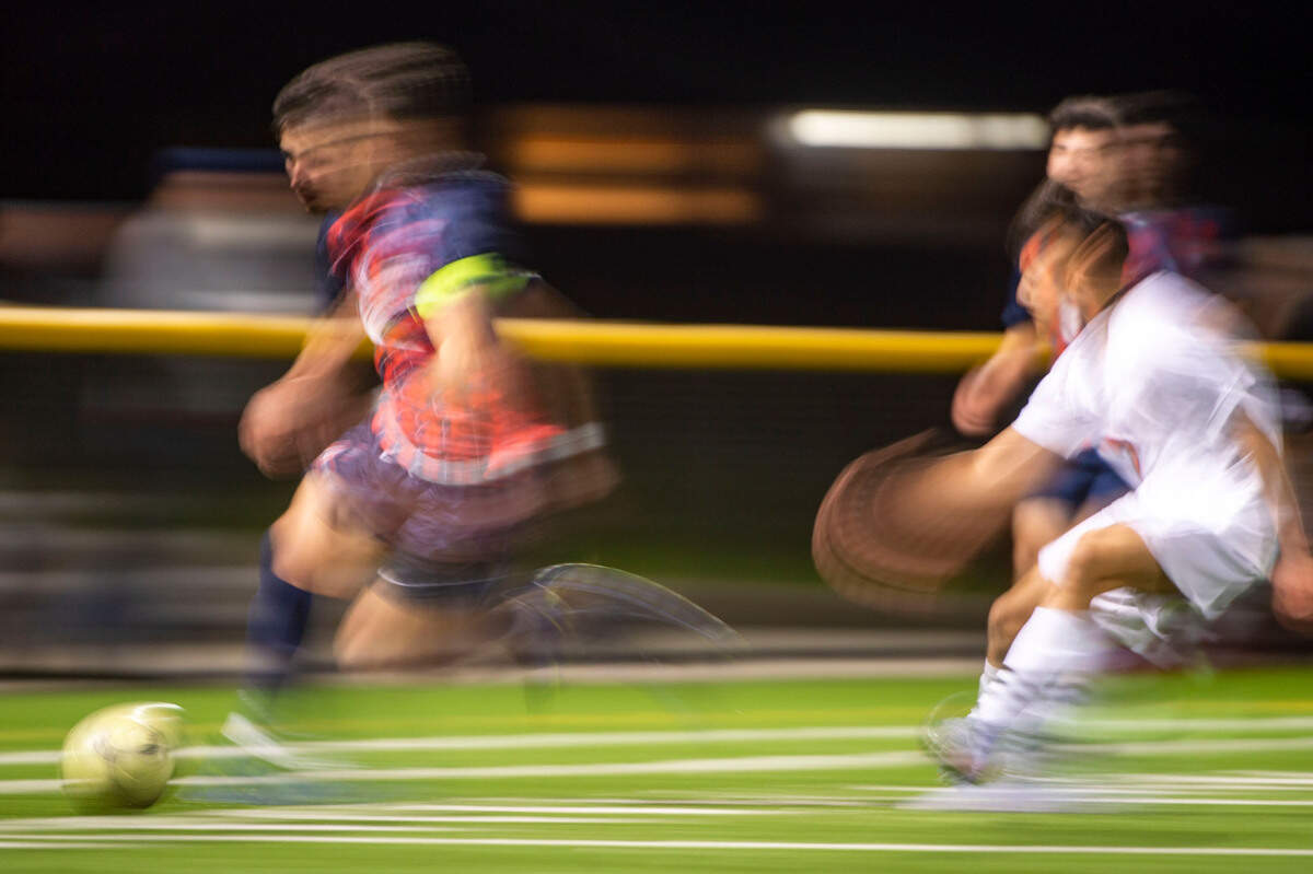 Silas midfielder Connor Tollan dribbles past a Lakes defender during the second half of a Pierce County League game on Thursday, March 31, 2022, at Silas High School in Tacoma, Wash.