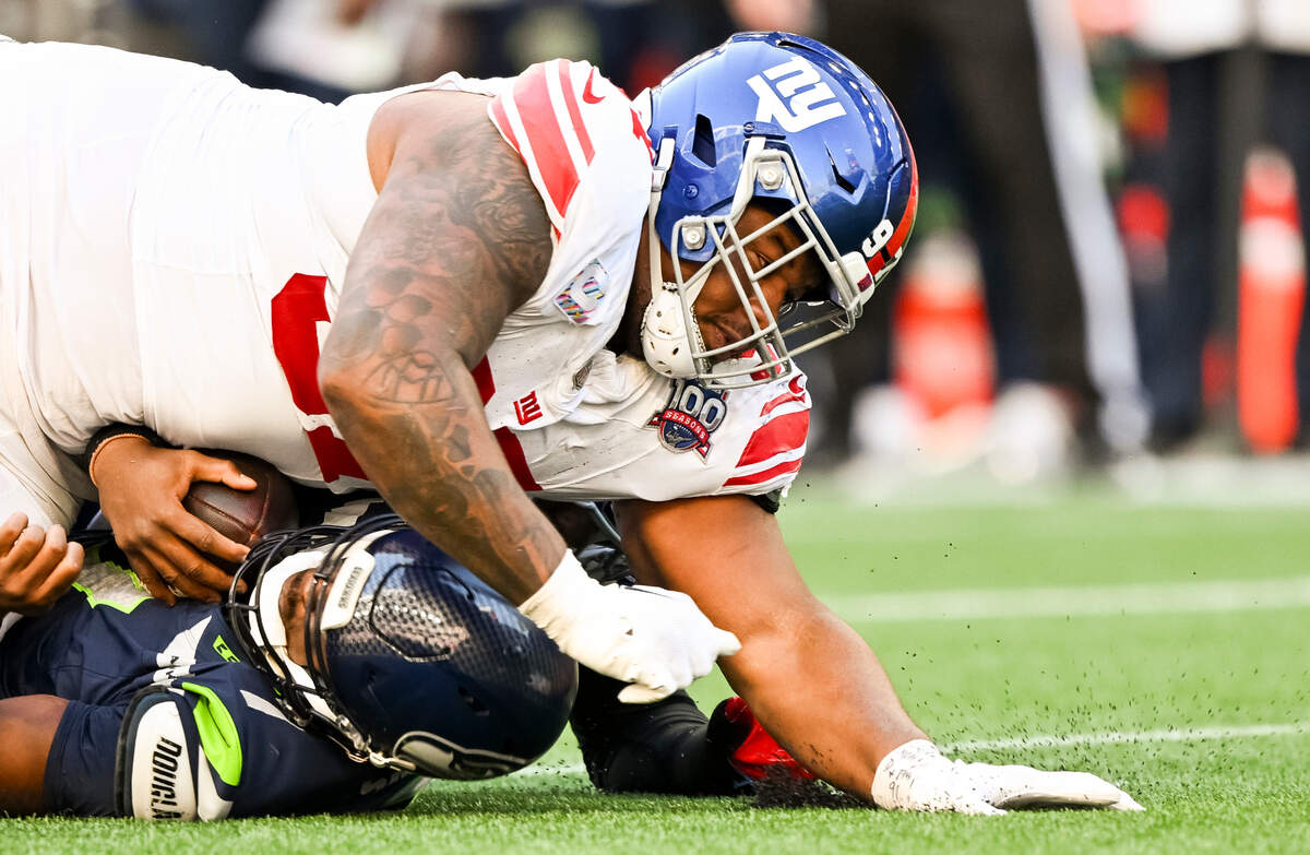 New York Giants defensive tackle Dexter Lawrence II (97) sacks Seattle Seahawks quarterback Geno Smith (7) during the fourth quarter of the game at Lumen Field, on Sunday, Oct. 6, 2024 in Seattle, Wash.