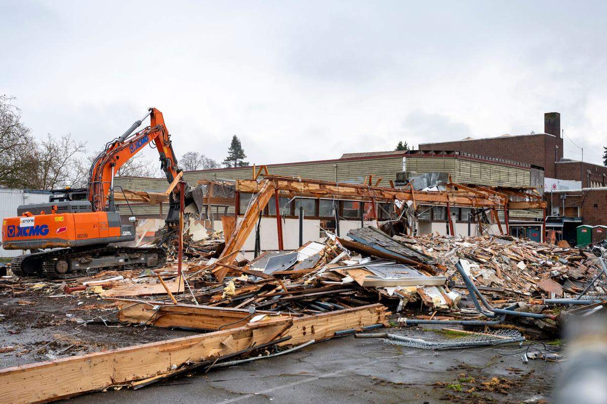 Brian Stone, who works for T-Stone Concrete, uses an excavator to demolish a science building at Gault Middle School in Tacoma on Thursday, April 14, 2022. T-Stone Concrete has the contract to demolish the gymnasium and a portable along with the science building.