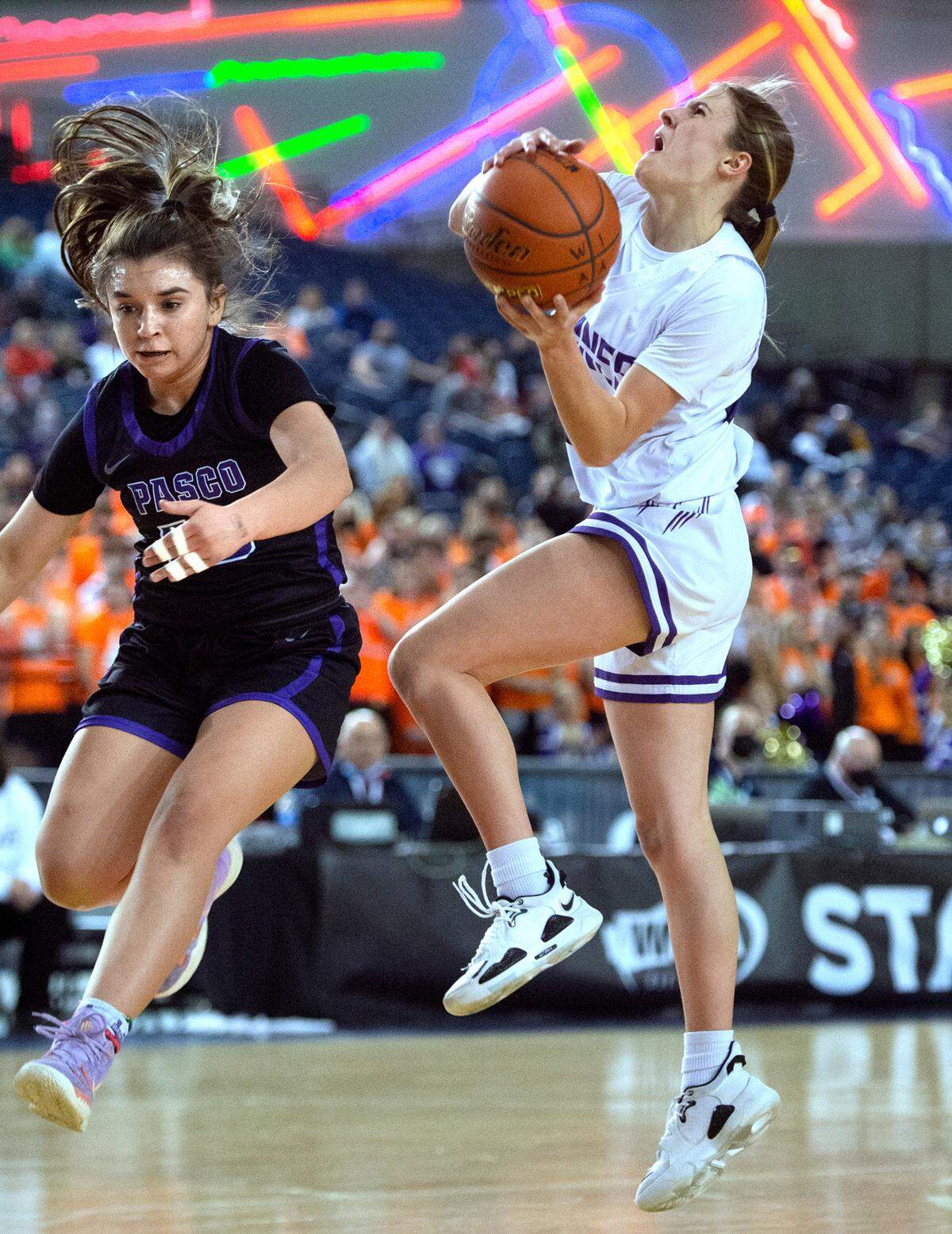 Sumner’s Lainee Houillon scores and draws the foul from Pasco defender Mireyah Lopez during Friday evening’s semifinal game of the WIAA 4A Girls Basketball State Championships tournament in the Tacoma Dome in Tacoma, Washington, on Friday, March 4, 2022.