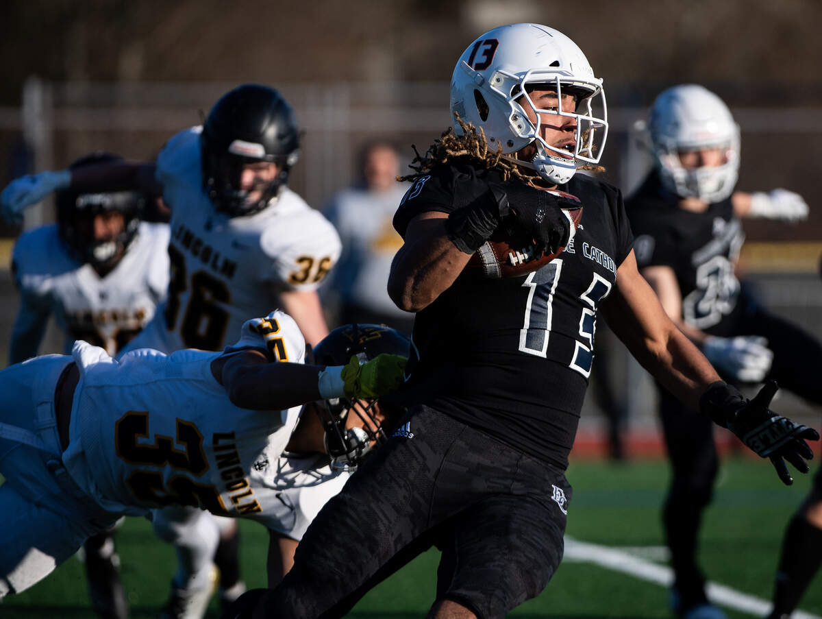 Lincoln’s Irae Savaiinaea tries to bring down Eastside Catholic’s Gee Scott Jr. during the third quarter. Lincoln played Eastside Catholic in the 3A football semifinal game at Sammamish High School in Bellevue, Wash., on Saturday, Nov. 30, 2019.