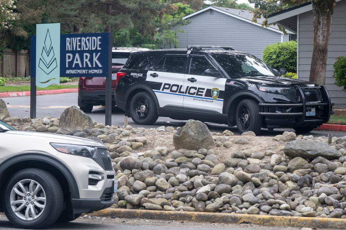 Puyallup police vehicles sit at the Riverside Park Apartments, where residents found a 3-year-old girl unresponsive on Thursday, May 15, 2025, at the complex on East Main Avenue in Puyallup.
