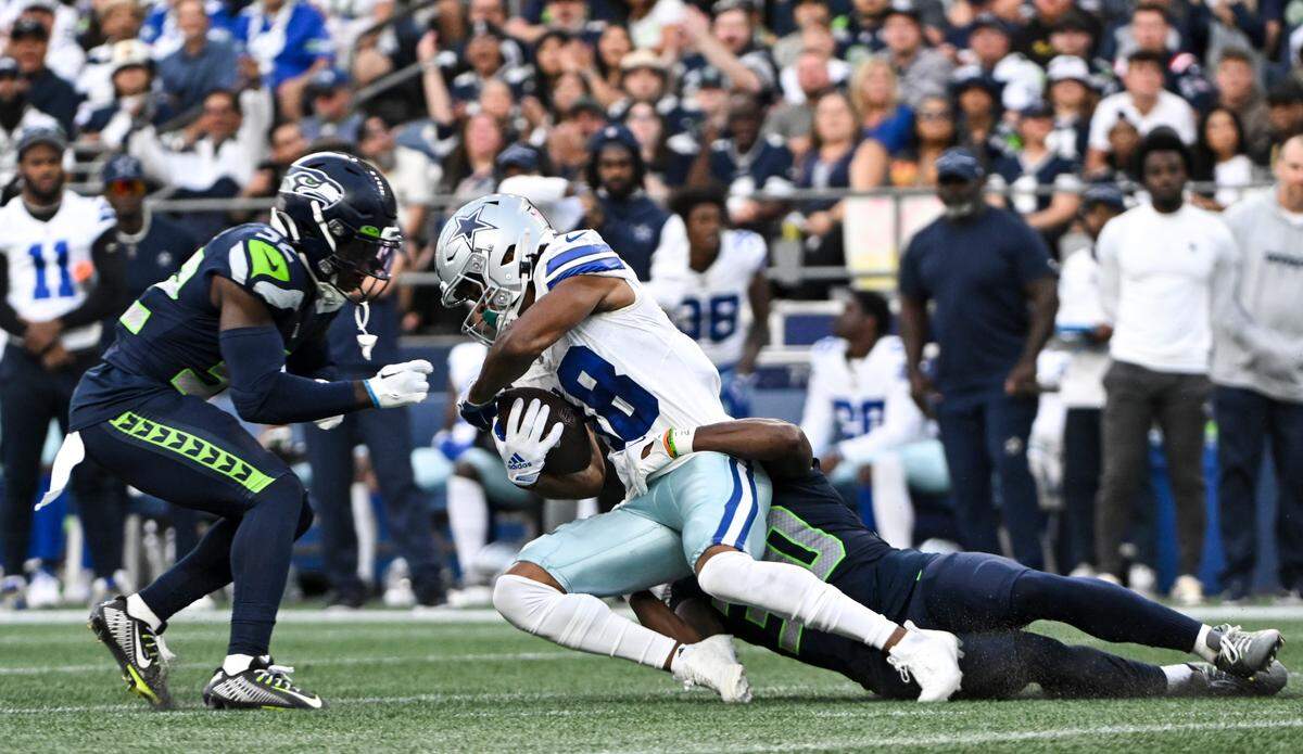 Seattle Seahawks cornerback Michael Jackson (30) brings down Dallas Cowboys wide receiver Jalen Tolbert (18) during the first quarter of the preseason game at Lumen Field, Saturday, Aug. 19, 2023, in Seattle, Wash.