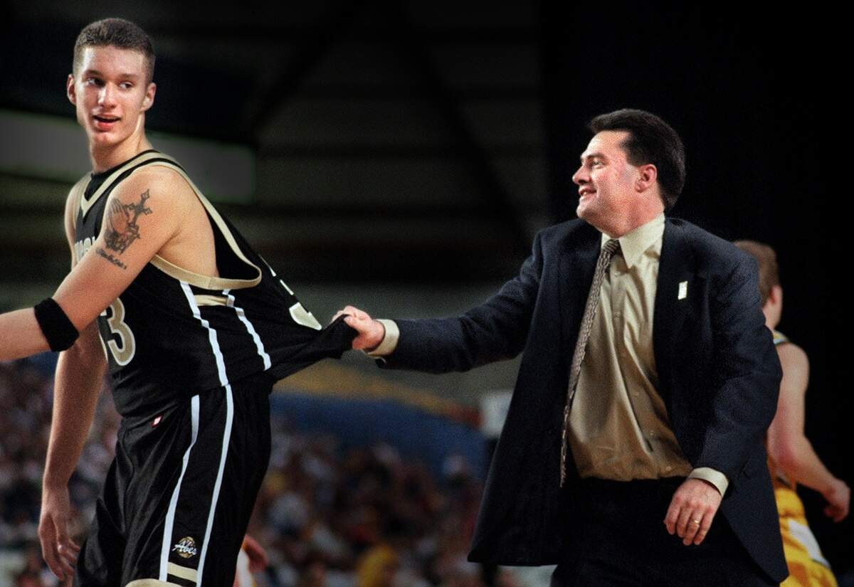 SPORTS-Lincoln head coach Tim Kelly has a grab of his big guy Justin Holt and tells the game high scorer not to argue for two more points which the referee called his basket went in after time expired and his coach explaining to him that their team having a 30 point lead in the game with Shadle Park. Friday, March 9, 2001 (Lui Kit Wong/The News Tribune)