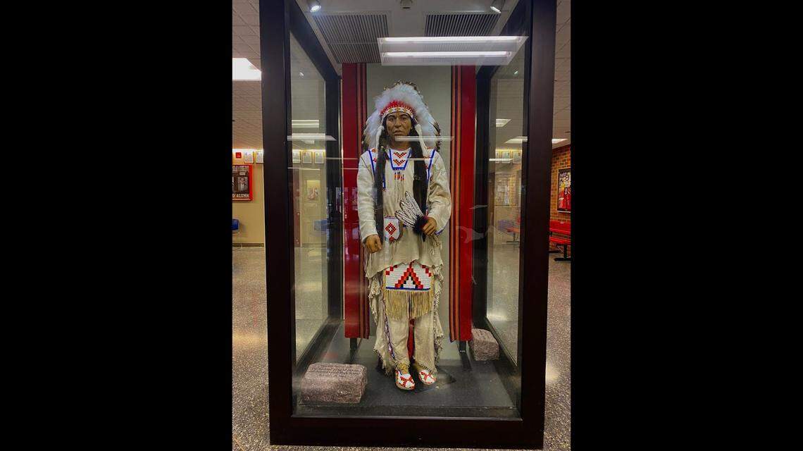 A male mannequin wearing regalia in the style of Great Plains tribes rather than that of the Coast Salish people of Washington state sits in the halls of North Central High School in Spokane, Wash. There’s also a female mannequin similarly dressed. A Washington state bill that bans Native mascots at public schools took effect July 25.