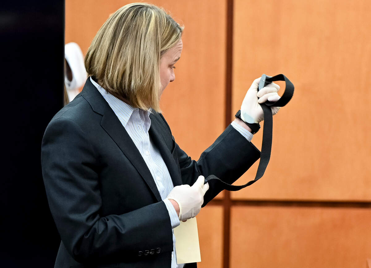 Washington State assistant attorney Lori Nicolavo holds up the hobble used on Manny Ellis from questioning Chris Nielsen, a use-of-force expert&nbsp;and law enforcement officer, on cross examination during the trial of three Tacoma Police officers in the killing of Manny Ellis at Pierce County Superior Court, Monday, Nov. 27, 2023, in Tacoma, Wash.Tacoma Police Officers Christopher Burbank, Matthew Collins and Timothy Rankine stand trial for charges related to the March 2020 killing of Manny Ellis. (Brian Hayes / Pool Photo – The News Tribune)
