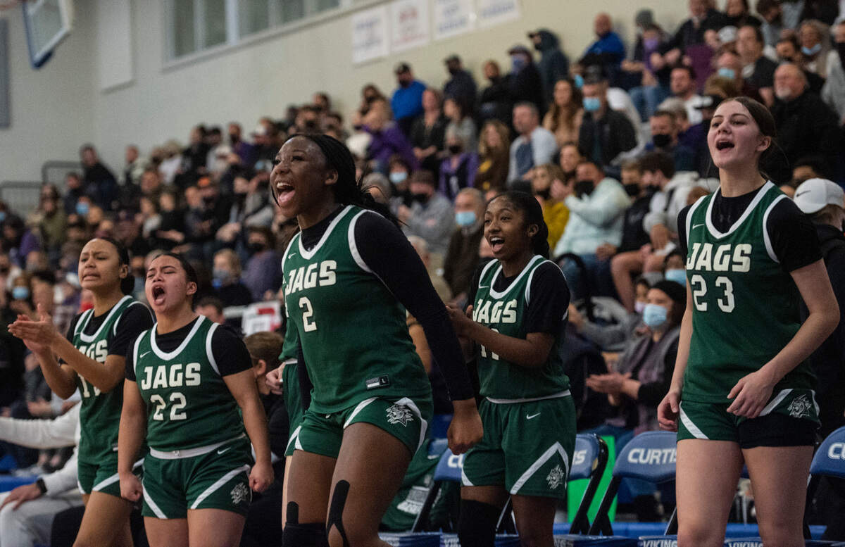 Emerald Ridge players cheer on their teammates from the bench during the 4A District 3/4 high school girls basketball championship game at the Curtis High School on Saturday, Feb. 19, 2022, in University Place, Wash.
