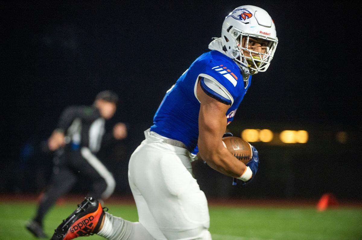 After catching a pass from quarterback Joshua Wood, Graham-Kapowsin tight end Andrew Savaiinaea runs toward the endzone for a touchdown during the fourth quarter of a State 4A quarterfinal game on Friday night at Art Crate Field in Spanaway.
