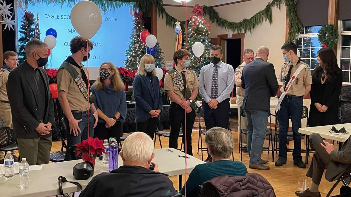 The new Eagle Scouts with their families receiving their Eagle Scout awards.