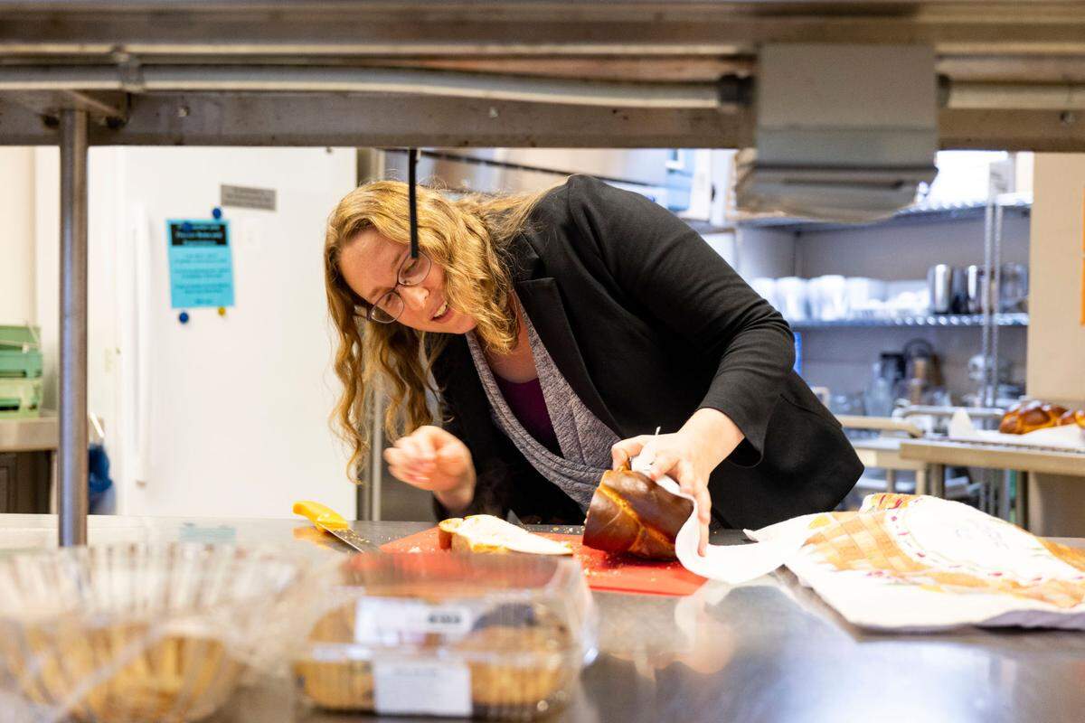 Rabbi Keren Gorban slices through challah bread in the kitchen at Temple Beth El in Tacoma on Friday, Oct. 14, 2022. Gorban, who started in the position on July 1, makes the challah bread herself.