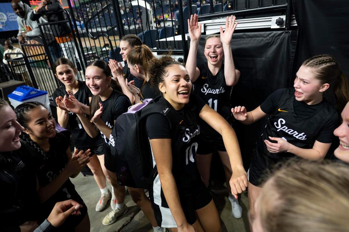 Sumner guard Olivia Collins (10) leads the celebration after the the Spartans beat Woodinville 46-39 in a Class 4A state basketball tournament semifinal game at the Tacoma Dome on Friday, March 7, 2025, in Tacoma, Wash.
